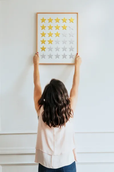A woman showcases a framed image of stars highlighting innovation and-imagination in Customer Experience Consulting